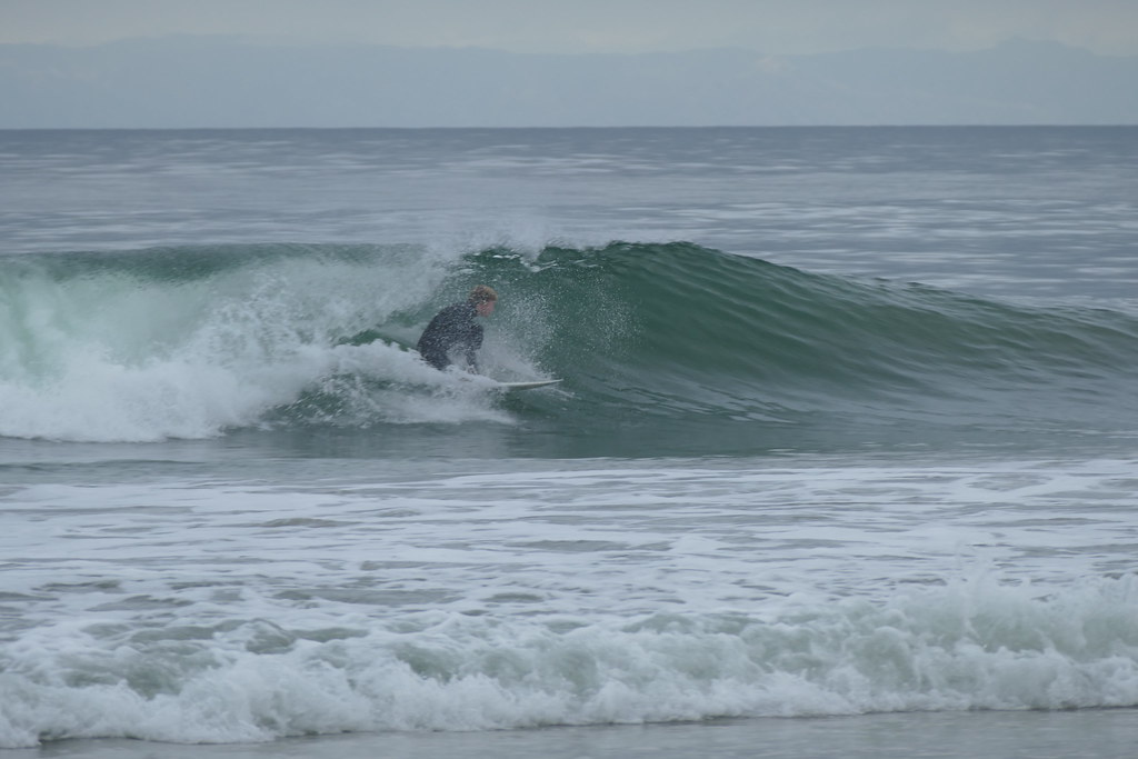 CdM surfer tucked into the pocket of a glassy green wall